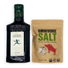 A bottle of Laudemio Frescorbaldi black vinegar next to a brown stand-up pouch of Omnivore Salt seasoning, shown on a plain white background.
