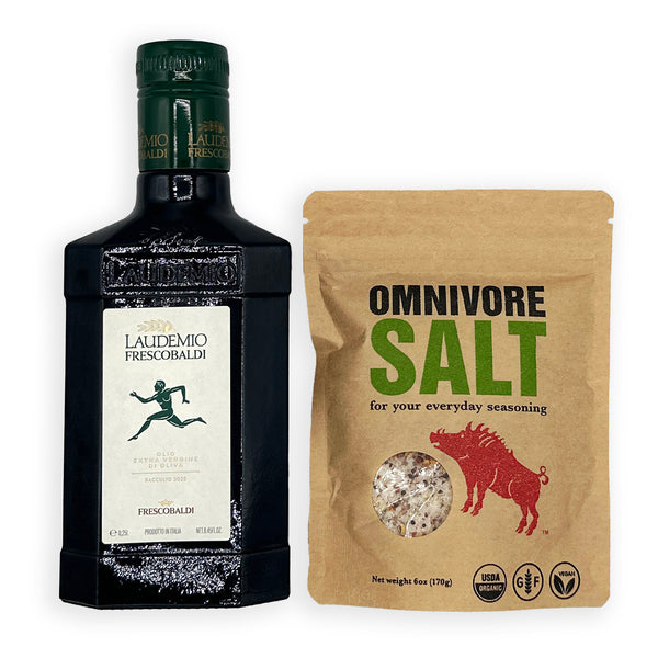 A bottle of Laudemio Frescorbaldi black vinegar next to a brown stand-up pouch of Omnivore Salt seasoning, shown on a plain white background.